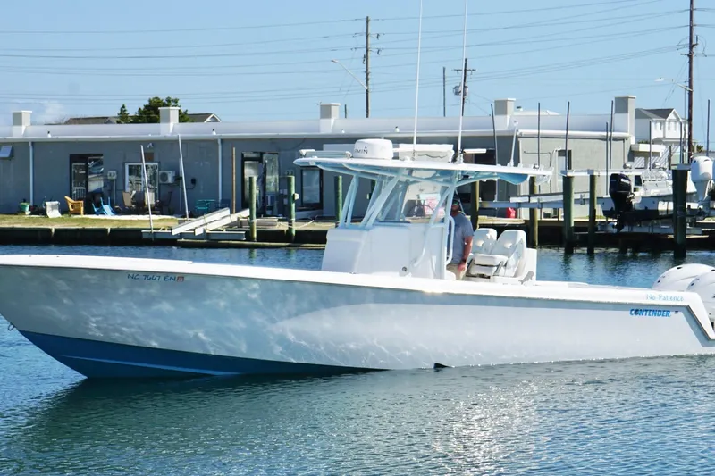 Slide: The Image of 2020 Contender 35 ST boat docked at marina, clear blue sky background. - 8