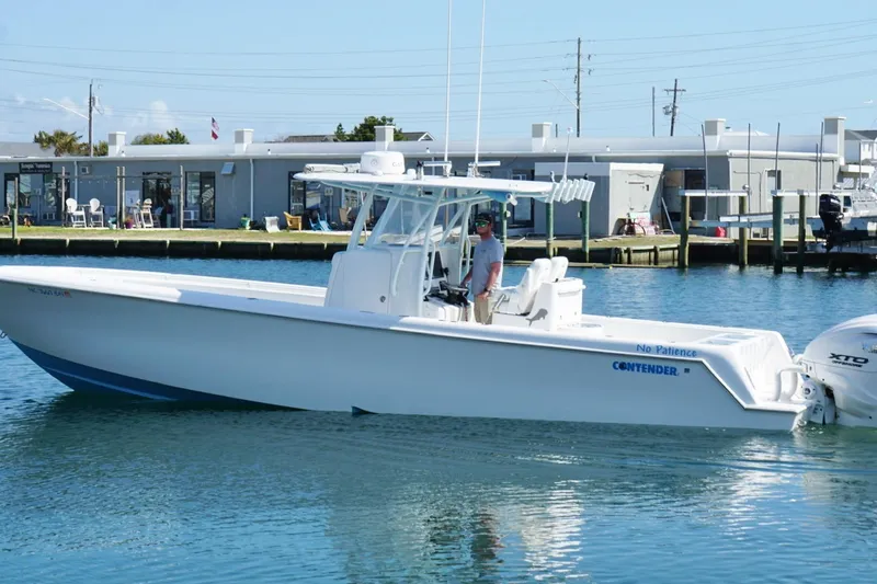 Slide: The Image of 2020 Contender 35 ST boat docked in marina, clear blue water, sunny day. - 9