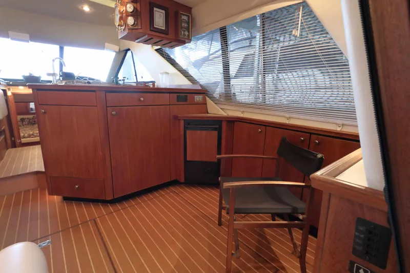 Slide: The Image of Interior of 1995 Bayliner 3988 Command Bridge Motoryacht with wooden cabinetry and seating. - 12