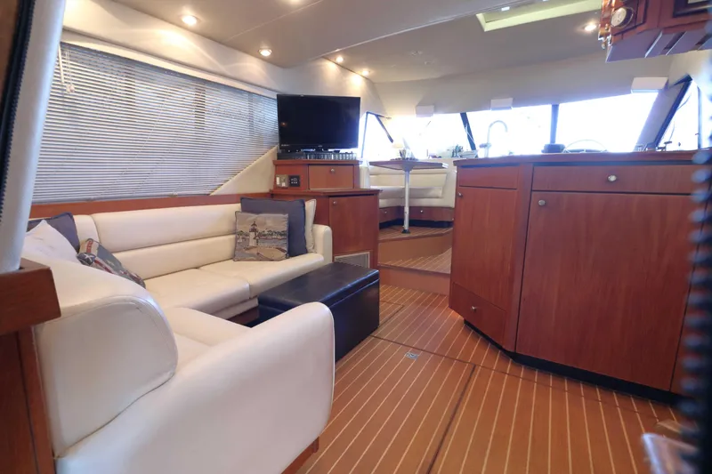 Slide: The Image of Luxurious interior of 1995 Bayliner 3988 Command Bridge Motoryacht with elegant seating and wood finishes. - 13