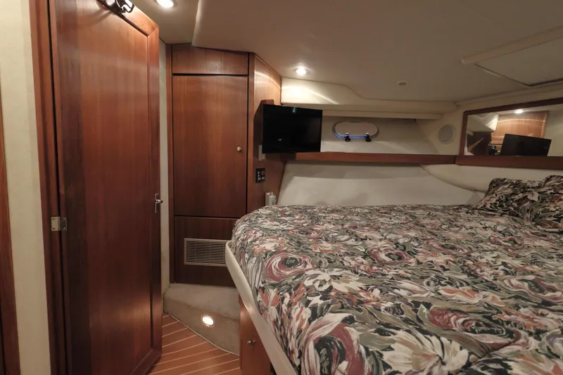 Slide: The Image of Luxurious cabin interior of 1995 Bayliner 3988 Command Bridge Motoryacht with floral bedding. - 18
