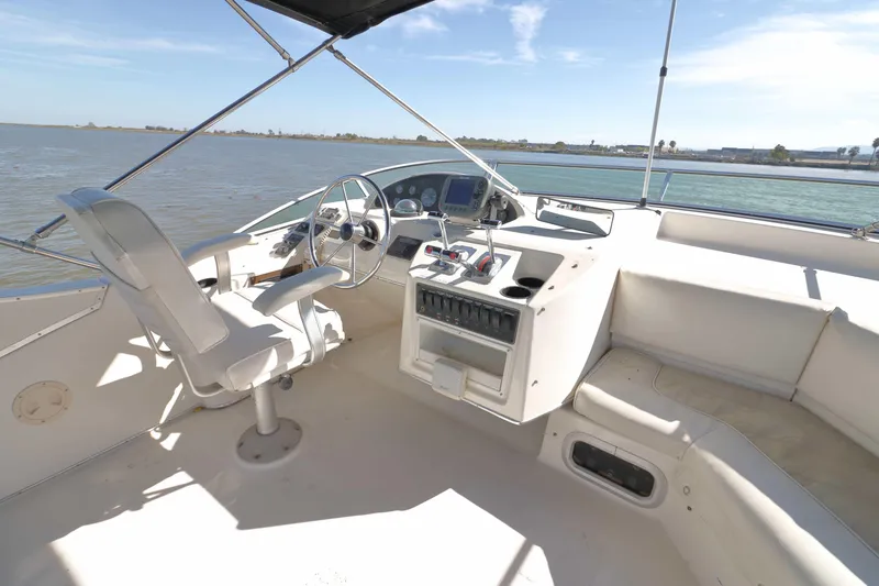 Slide: The Image of 1995 Bayliner 3988 Command Bridge Motoryacht helm with steering wheel and controls. - 2