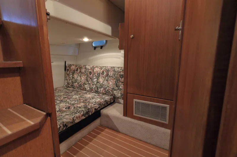 Slide: The Image of 1995 Bayliner 3988 Command Bridge Motoryacht cabin with floral upholstery and wooden interior. - 20