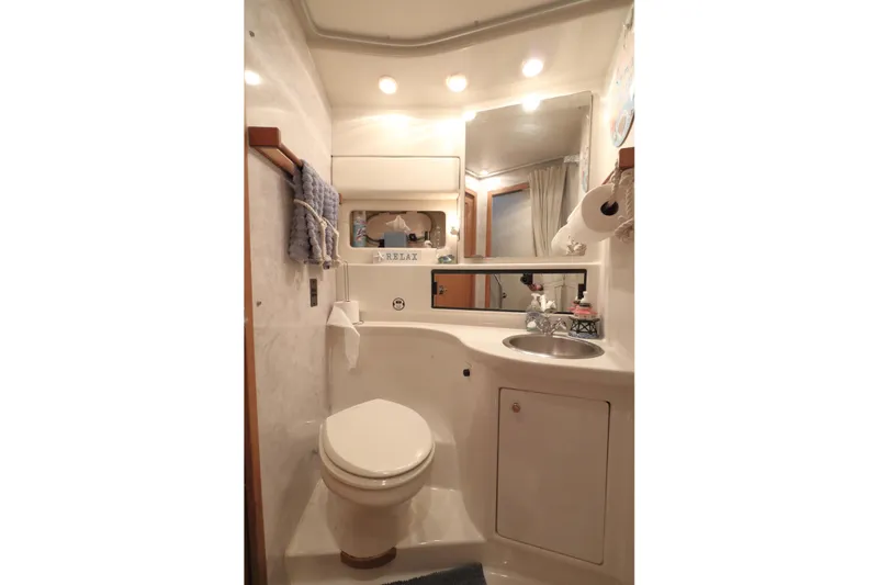 Slide: The Image of Bathroom interior of 1995 Bayliner 3988 Command Bridge Motoryacht, featuring sink and toilet. - 22