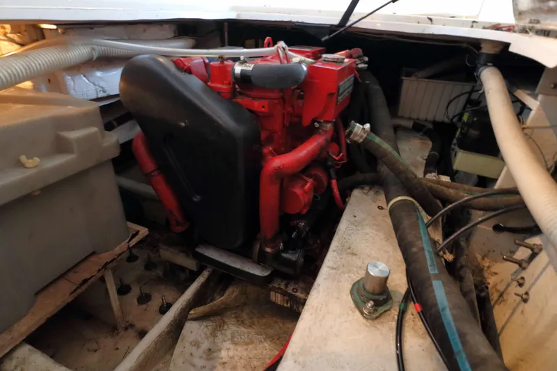 Slide: The Image of Engine compartment of a 1995 Bayliner 3988 Command Bridge Motoryacht, featuring red engine components. - 25