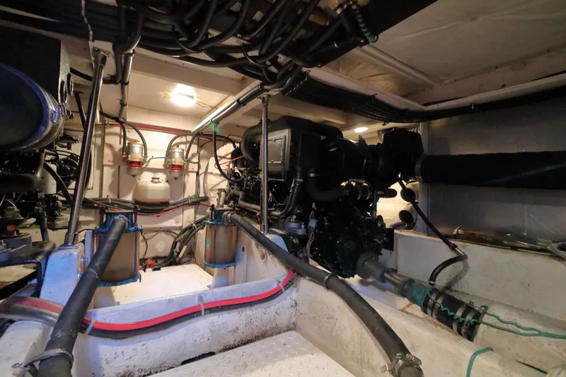 Slide: The Image of Engine room of 1995 Bayliner 3988 Command Bridge Motoryacht, showcasing mechanical components and wiring. - 27