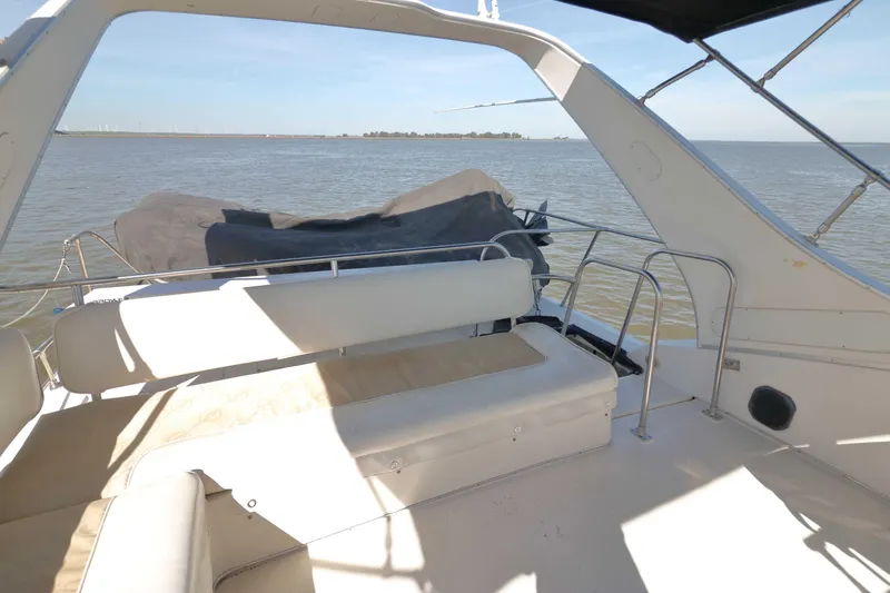 Slide: The Image of 1995 Bayliner 3988 Command Bridge Motoryacht, spacious deck overlooking serene waters. - 3