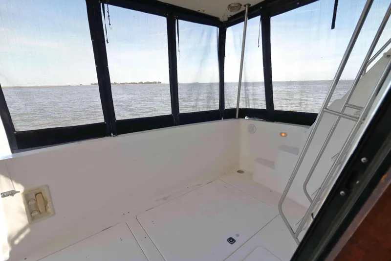 Slide: The Image of 1995 Bayliner 3988 Command Bridge Motoryacht interior with ocean view and ladder. - 6
