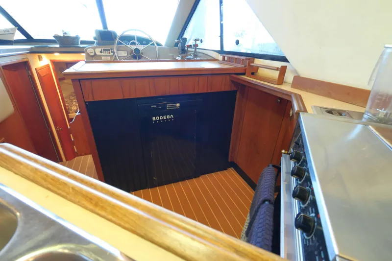 Slide: The Image of Interior of 1995 Bayliner 3988 Command Bridge Motoryacht with kitchen and steering area. - 8