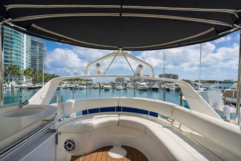 Slide: The Image of 2004 Carver 420 Mariner yacht interior with marina view, featuring luxurious seating and modern amenities. - 11