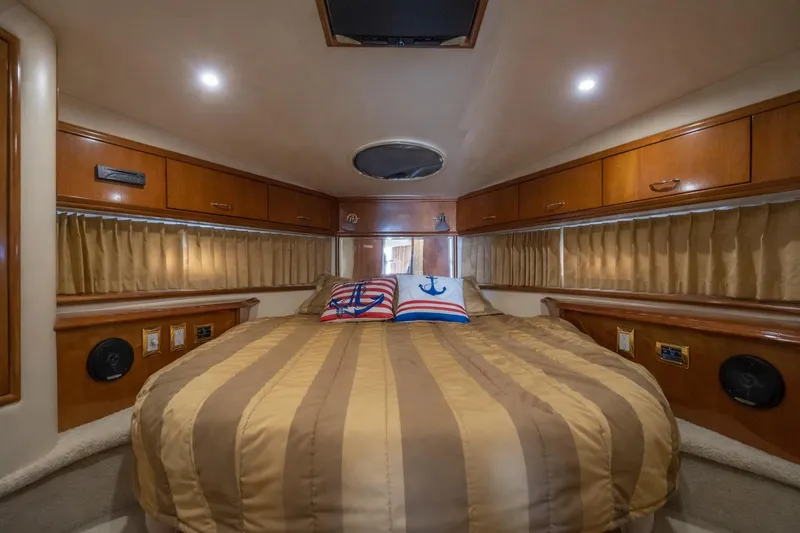 Slide: The Image of Luxurious 2004 Carver 420 Mariner cabin interior with cozy bed and nautical decor. - 14