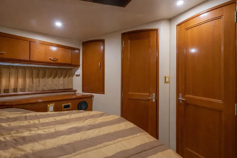 Slide: The Image of 2004 Carver 420 Mariner cabin interior with wood paneling and cozy bedding. - 15