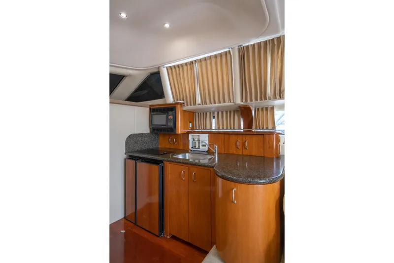 Slide: The Image of 2004 Carver 420 Mariner yacht kitchen with wood cabinetry and modern appliances. - 19
