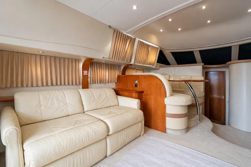Slide: The Image of Luxurious interior of 2004 Carver 420 Mariner yacht with cream leather seating and wood accents. - 20
