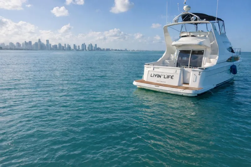 Slide: The Image of 2004 Carver 420 Mariner yacht on blue ocean with city skyline in background. - 4