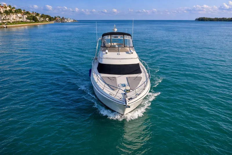 Slide: The Image of 2004 Carver 420 Mariner yacht cruising on clear blue water. - 5