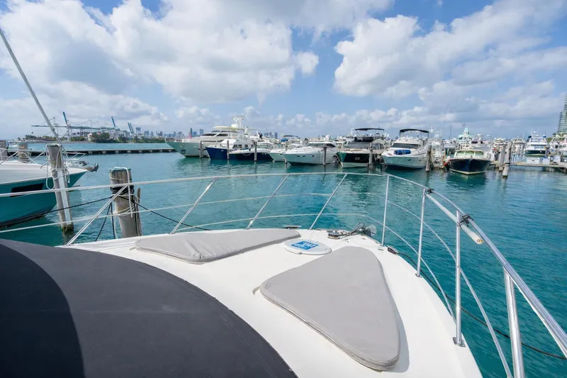 Slide: The Image of 2004 Carver 420 Mariner yacht docked in a marina with clear blue skies. - 8
