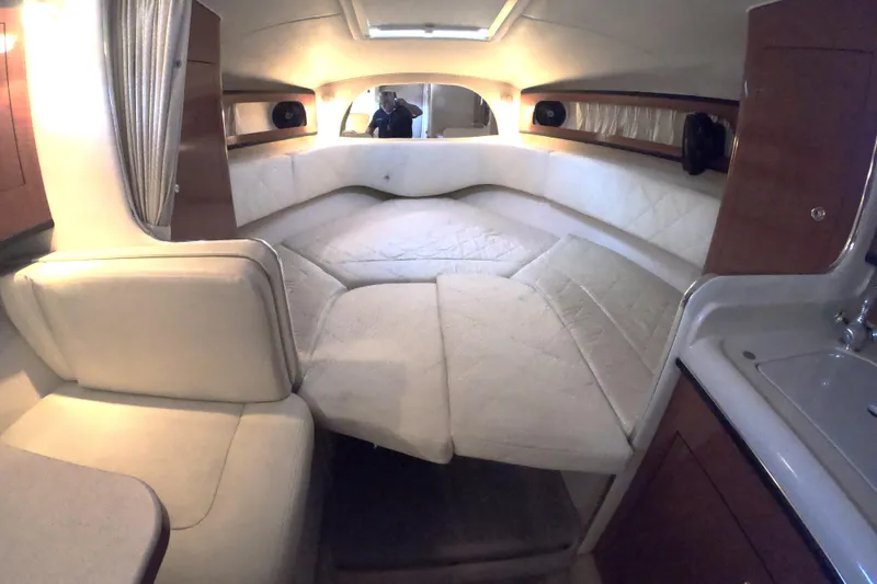 Slide: The Image of 2004 Sea Ray Sundancer 280 cabin interior with cozy seating and elegant design. - 12