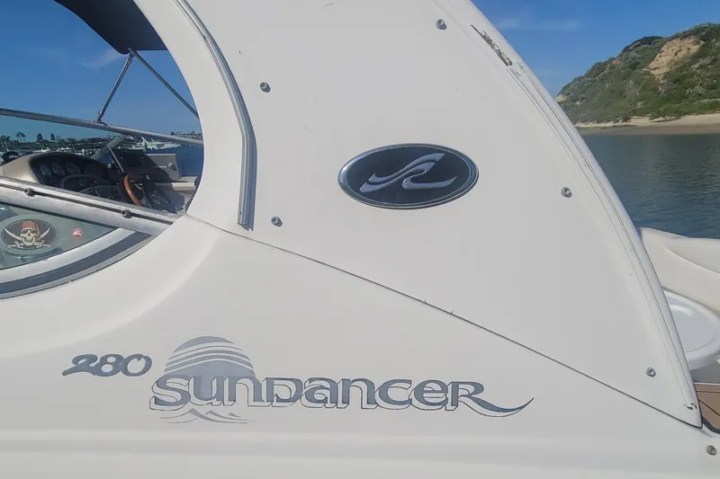 Slide: The Image of 2004 Sea Ray Sundancer 280 boat side view with logo and steering wheel. - 21