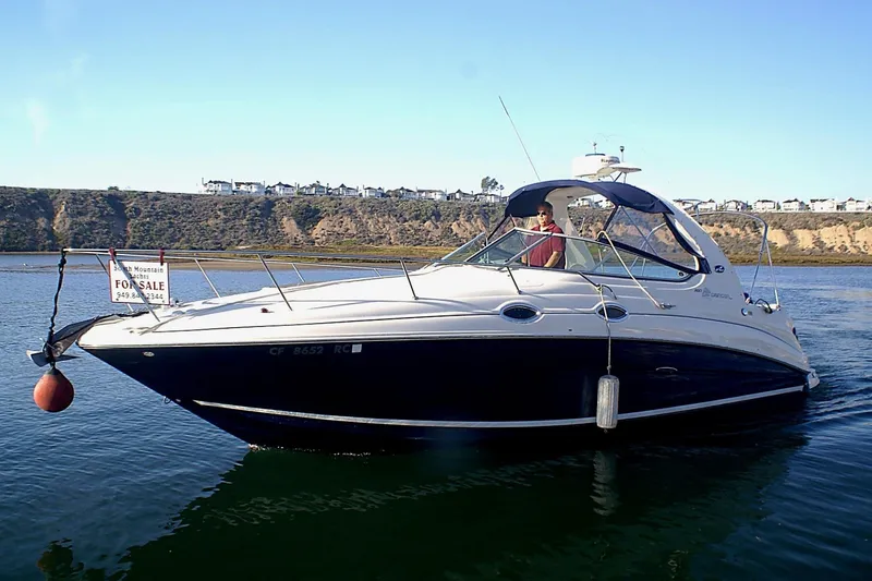 Slide: The Image of 2004 Sea Ray Sundancer 280 boat on water, for sale sign visible. - 3