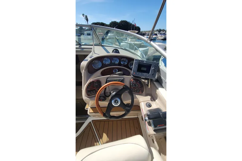 Slide: The Image of 2004 Sea Ray Sundancer 280 helm with steering wheel and navigation instruments. - 6