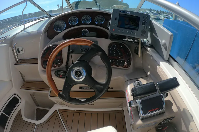 Slide: The Image of 2004 Sea Ray Sundancer 280 helm with wood accents and navigation equipment. - 7