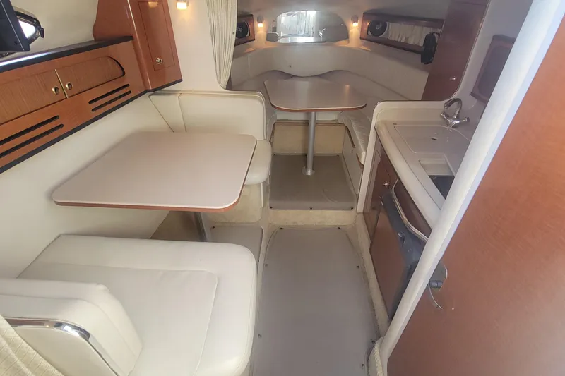 Slide: The Image of 2004 Sea Ray Sundancer 280 cabin interior with dining area and kitchenette. - 8