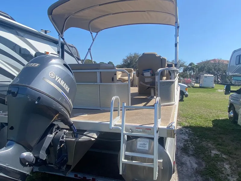 Slide: The Image of Interior of a 2019 Bennington 198SL pontoon boat with beige seating. - 2