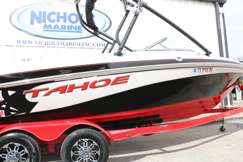 Slide: The Image of 2010 Tahoe Q7i boat on red trailer at Nichols Marine dealership. - 11