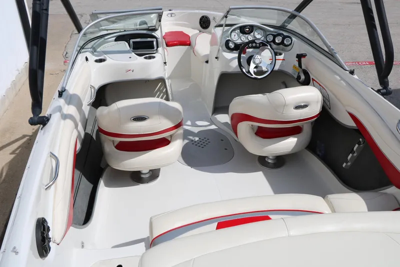 Slide: The Image of 2010 Tahoe Q7i boat interior with white and red seating, steering wheel, and dashboard controls. - 17