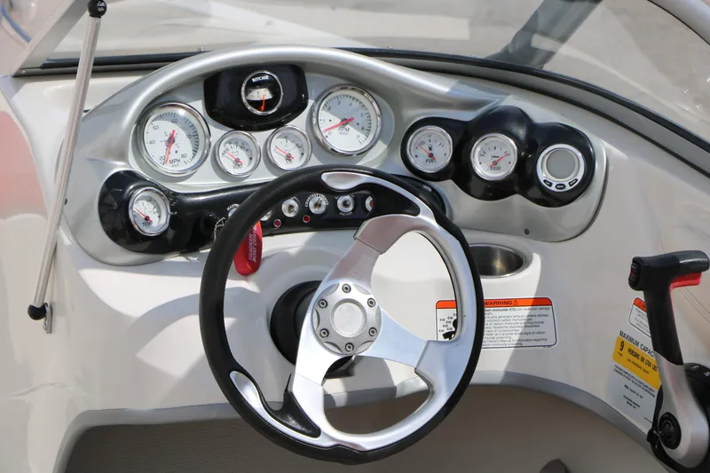Slide: The Image of Dashboard of a 2010 Tahoe Q7i boat with steering wheel and gauges. - 19