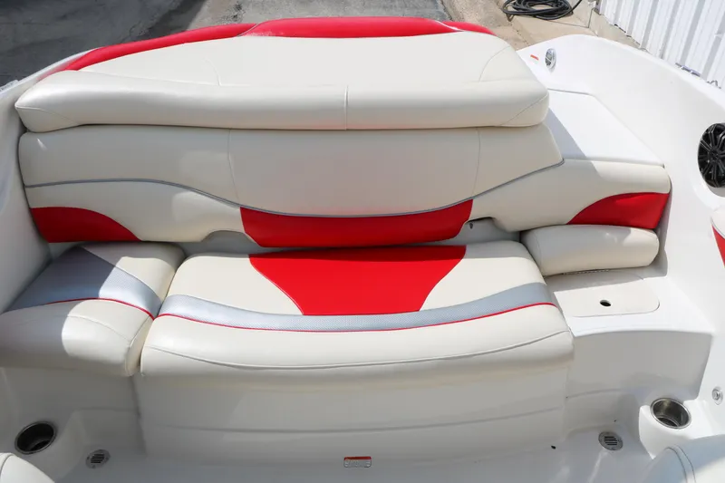 Slide: The Image of 2010 Tahoe Q7i boat interior with red and white cushioned seating. - 26