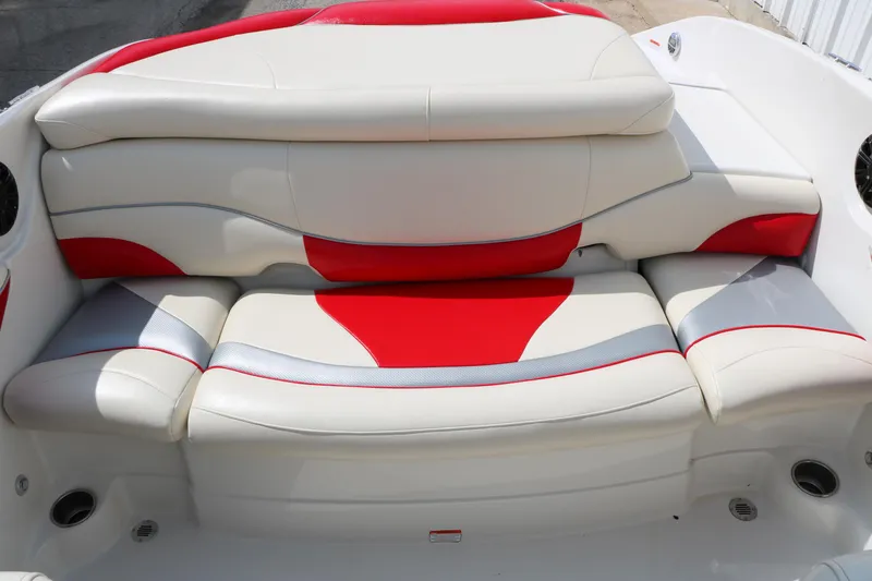 Slide: The Image of 2010 Tahoe Q7i boat interior with red and white cushioned seating. - 27