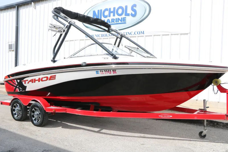 Slide: The Image of 2010 Tahoe Q7i boat on red trailer at Nichols Marine dealership. - 3