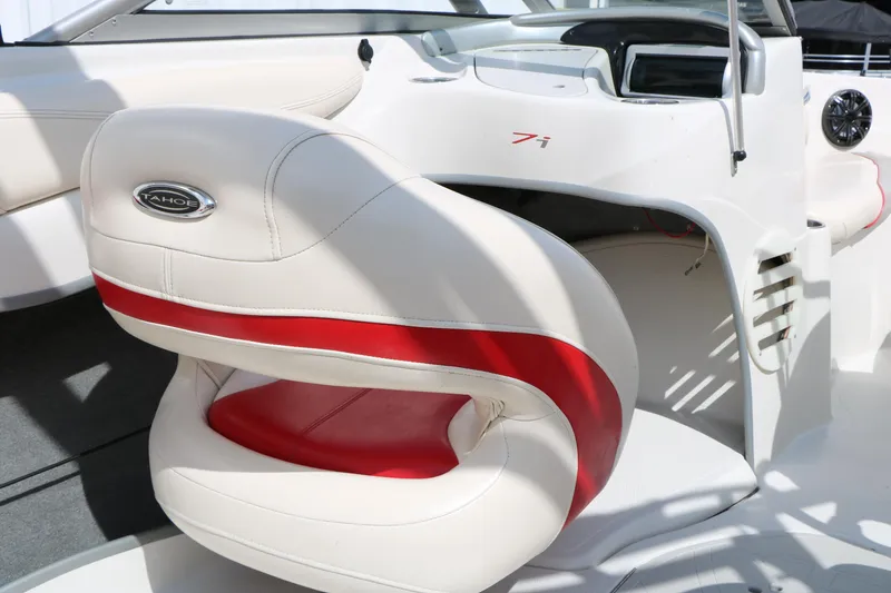 Slide: The Image of 2010 Tahoe Q7i boat interior with white and red seating, steering console visible. - 31