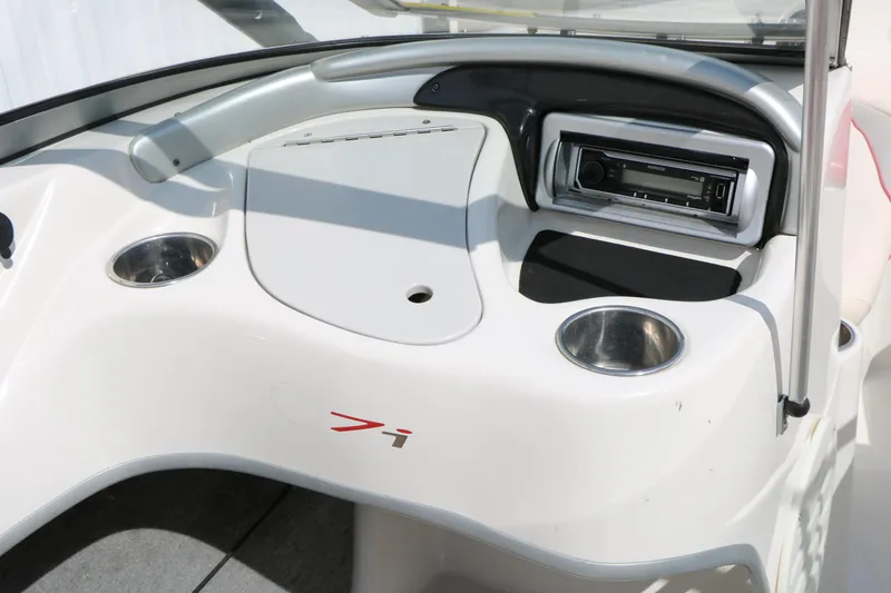 Slide: The Image of 2010 Tahoe Q7i boat dashboard with stereo and cup holders. - 32