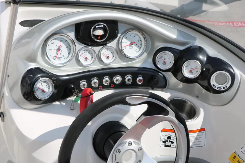 Slide: The Image of Dashboard of a 2010 Tahoe Q7i boat with gauges and controls. - 35