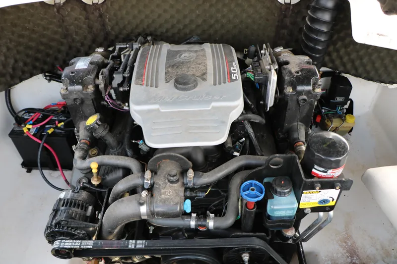 Slide: The Image of Engine compartment of a 2010 Tahoe Q7i boat, featuring a MerCruiser 5.0L engine. - 36