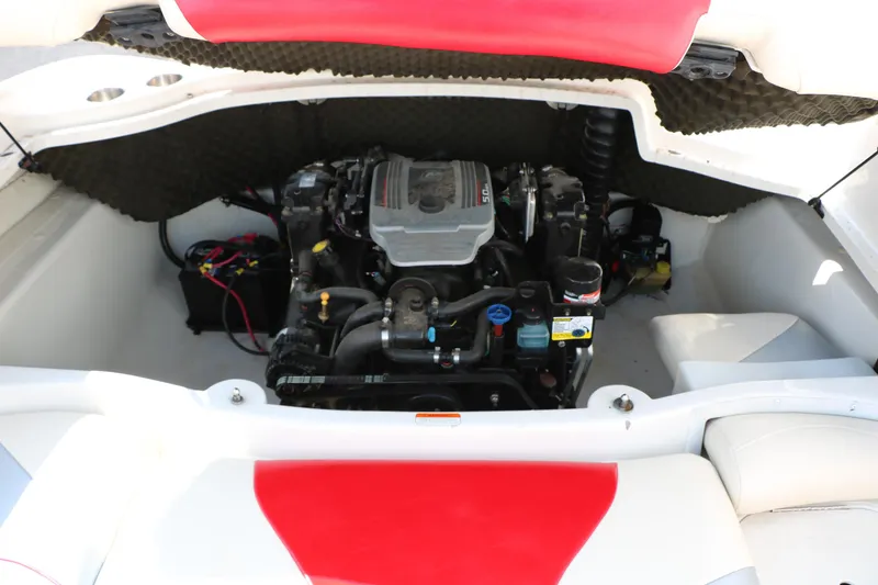 Slide: The Image of Engine compartment of a 2010 Tahoe Q7i boat, featuring a well-maintained motor. - 38