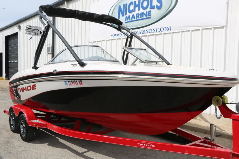 Slide: The Image of 2010 Tahoe Q7i boat on red trailer at Nichols Marine dealership. - 4
