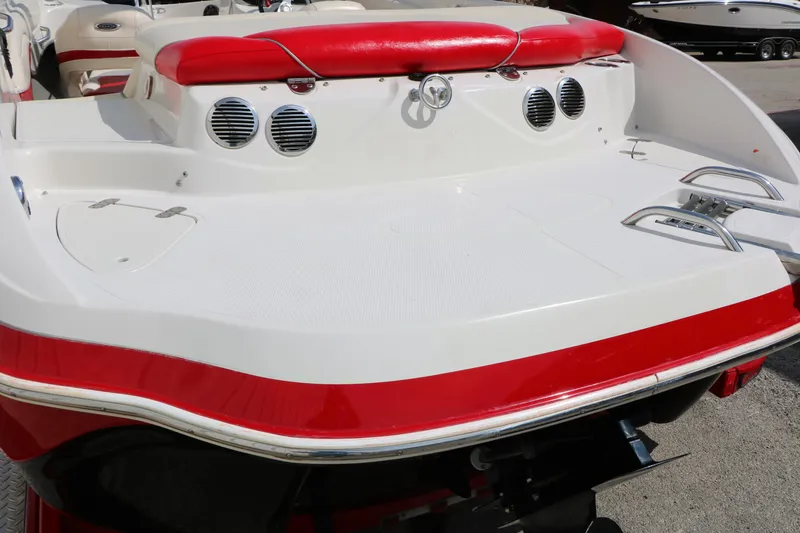 Slide: The Image of 2010 Tahoe Q7i boat with red and white design, featuring rear deck and seating. - 43