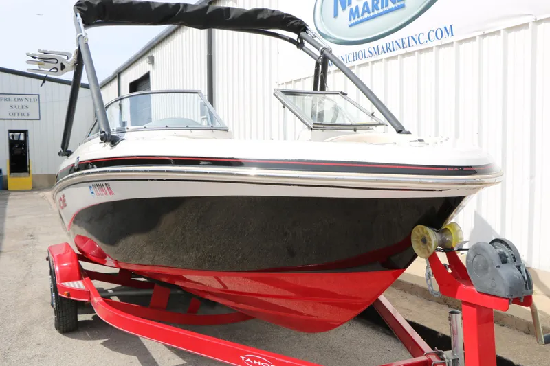 Slide: The Image of 2010 Tahoe Q7i boat on red trailer at marine sales office. - 5