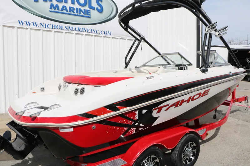 Slide: The Image of 2010 Tahoe Q7i boat with red and white design on trailer at Nichols Marine. - 7