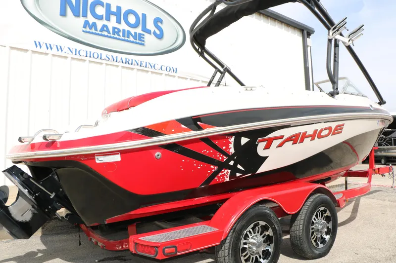 Slide: The Image of 2010 Tahoe Q7i boat on red trailer at Nichols Marine dealership. - 8