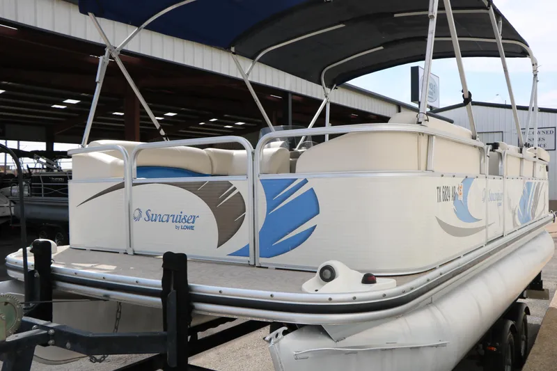 Slide: The Image of 2008 Sun Cruiser SS200 pontoon boat with blue and white design, docked in a marina. - 10