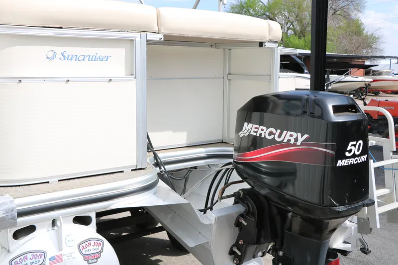 Slide: The Image of 2008 Sun Cruiser SS200 boat with Mercury 50 outboard motor, docked outdoors. - 12