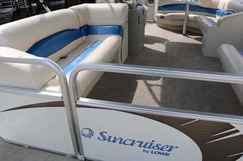 Slide: The Image of 2008 Sun Cruiser SS200 pontoon boat with beige and blue seating, spacious interior. - 16