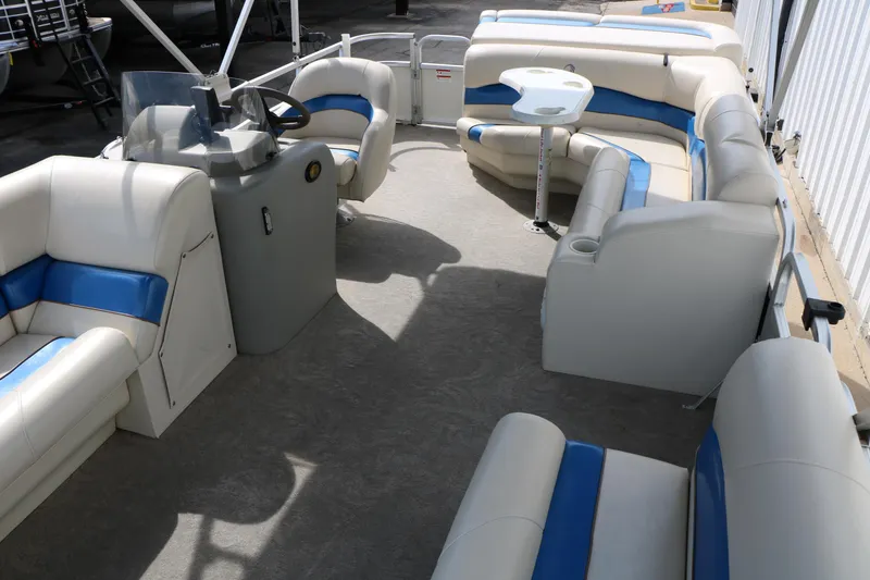 Slide: The Image of 2008 Sun Cruiser SS200 pontoon boat interior with blue and white seating and steering console. - 17
