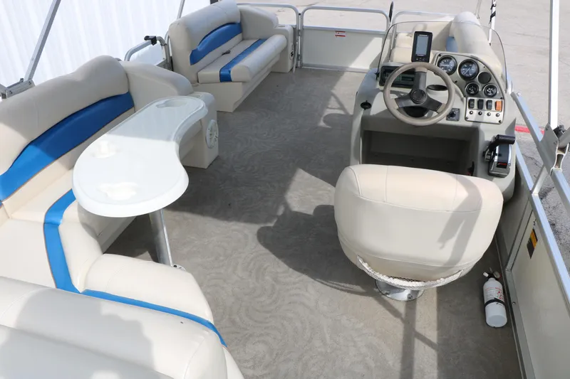 Slide: The Image of Interior of a 2008 Sun Cruiser SS200 pontoon boat with beige seating and control panel. - 19