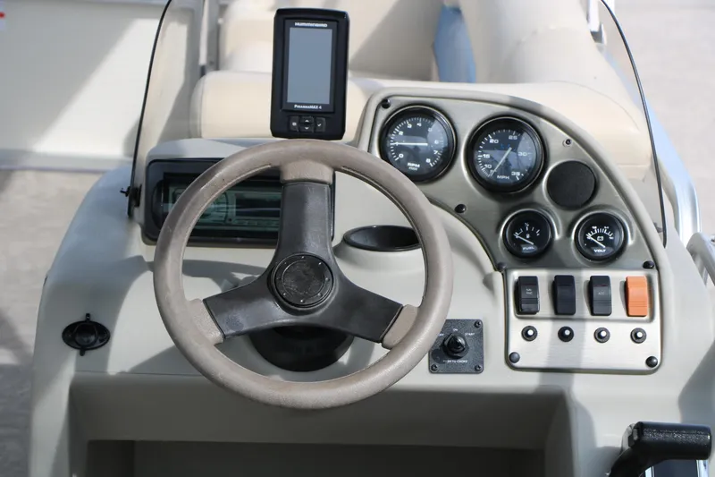Slide: The Image of Steering console of 2008 Sun Cruiser SS200 boat with gauges and controls. - 22